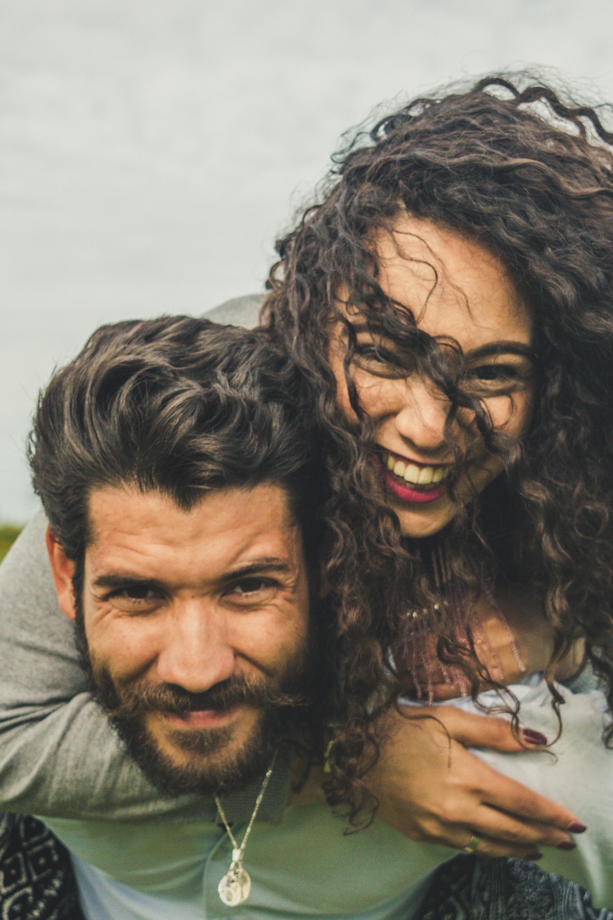 Couple laughing together in a field